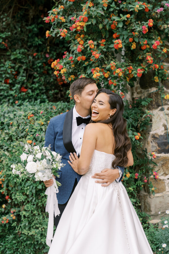 groom kissing bride on the cheek
