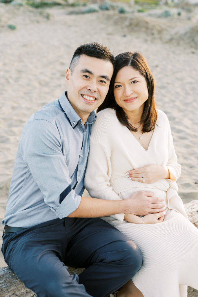 couple sitting smiling maternity