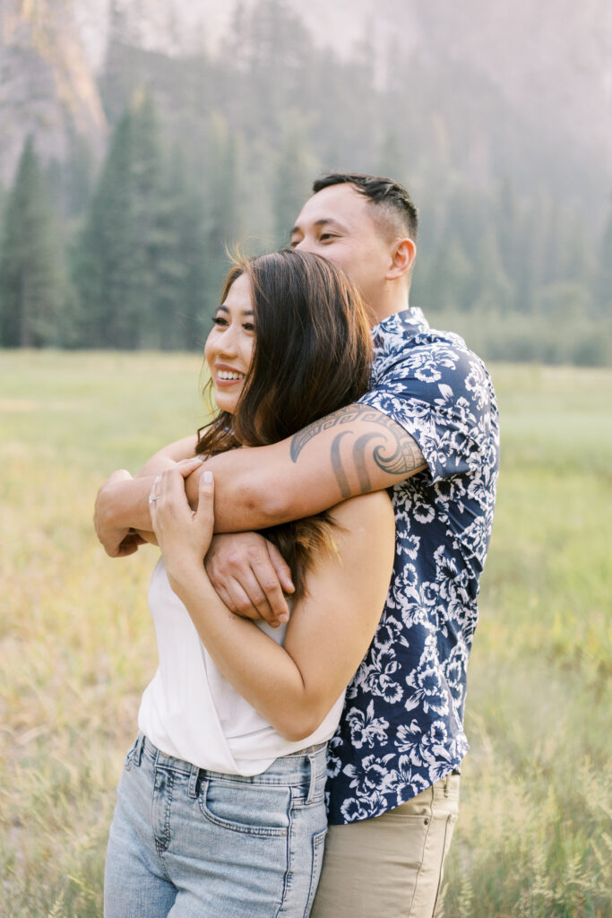 Couple hugging in soft sunset light