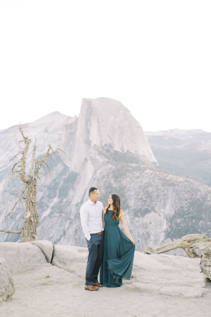 Newly engaged couple smiling together outdoors