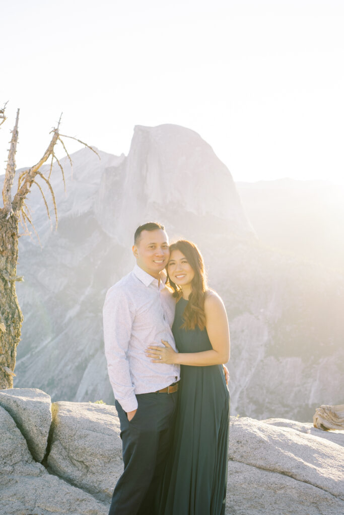 Newly engaged pair embracing in natural light