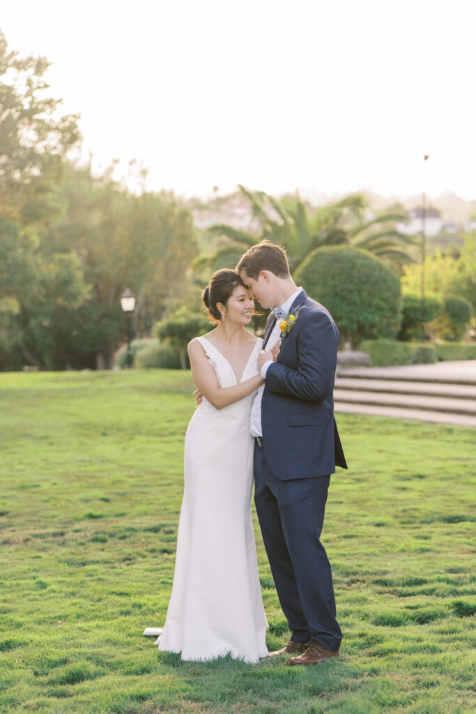 newly wed posing for a photo in a garden