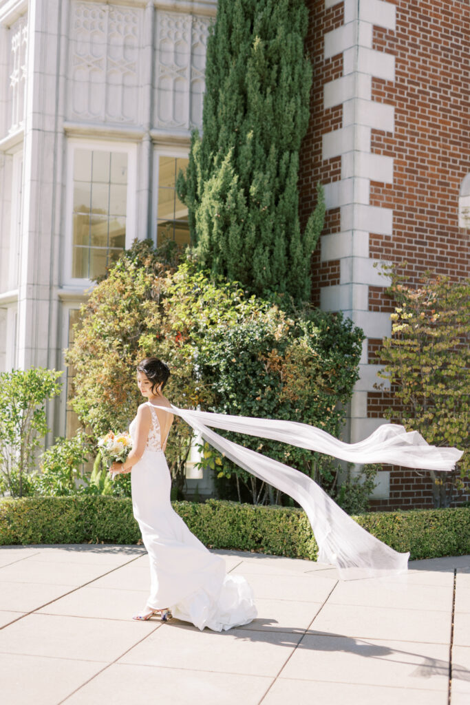 Bride posing outdoors in flowing white gown