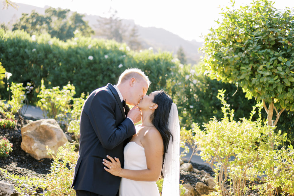 bride and groom kiss during golden hour