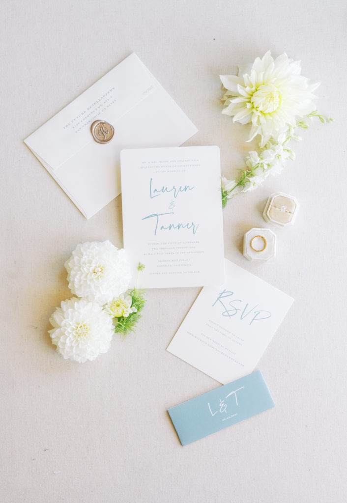 blue and white invitation suite flat lay