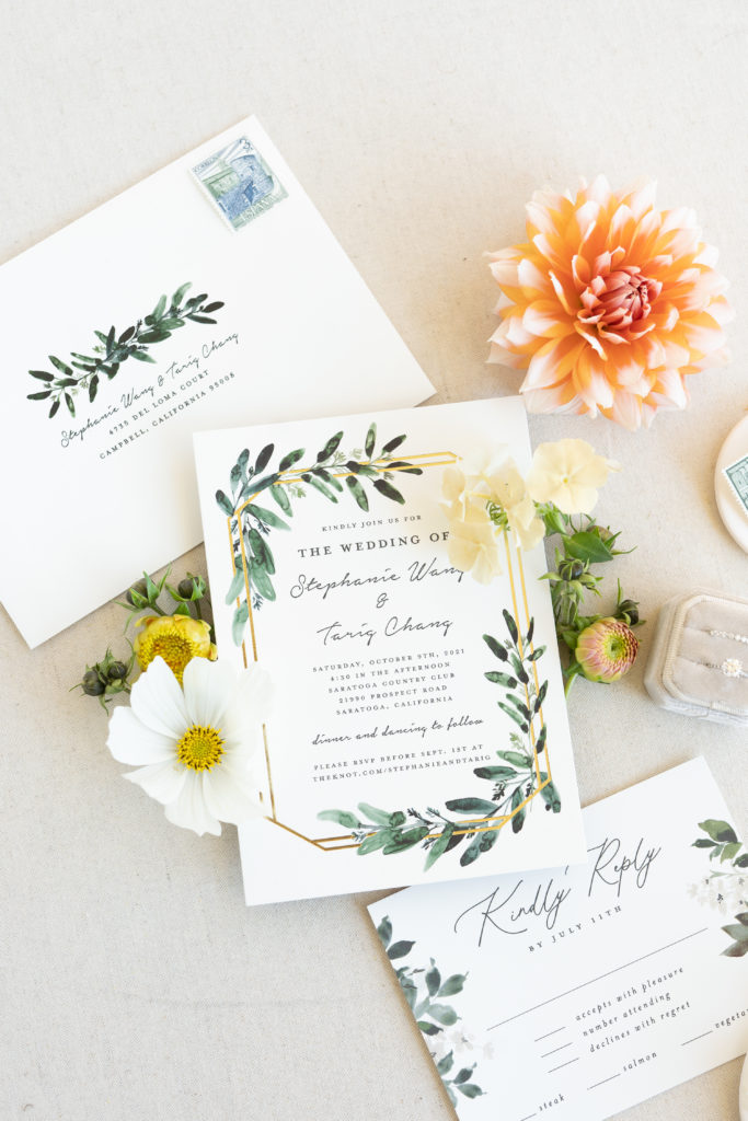 close up of minted invitation suite