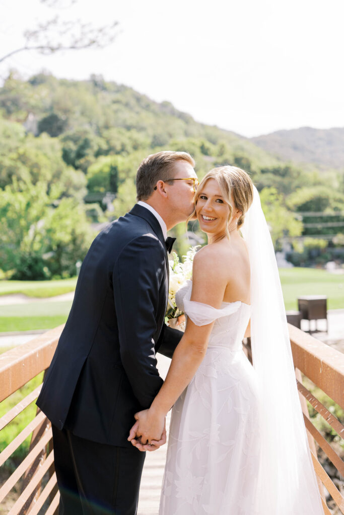 groom kissing bride's cheek