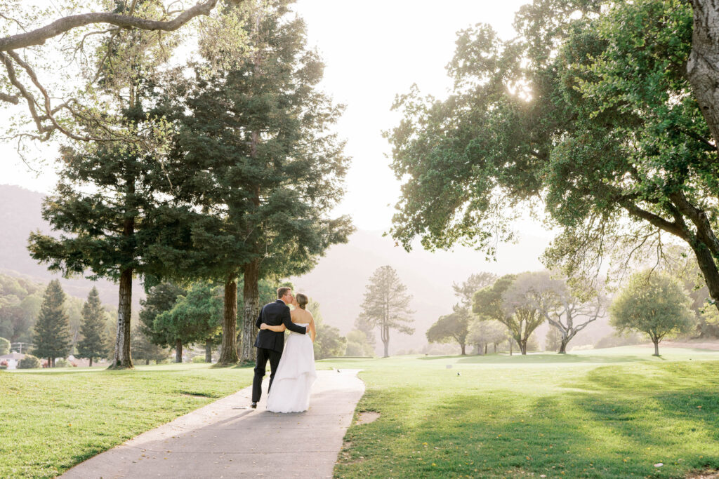 bride and groom hugging in the park