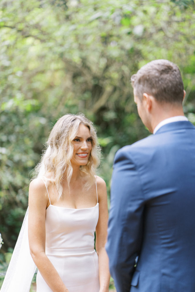 Caucasian bride and groom looking at each other in nature