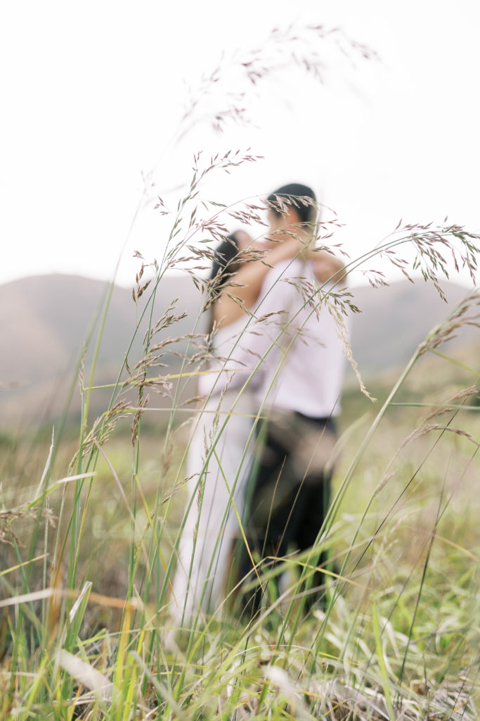 blur background bride and groom kissing
