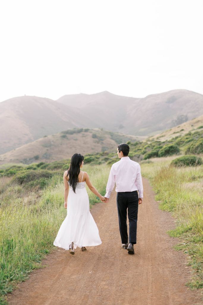 bride and groom holding hands in nature