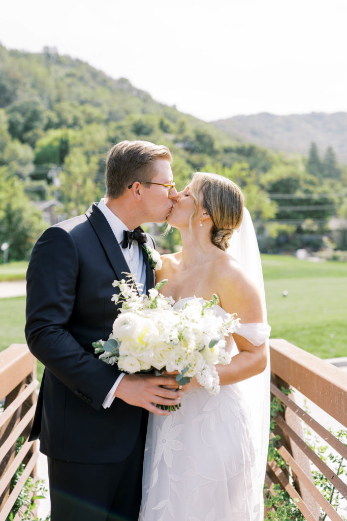 bride and groom kissing at a country club