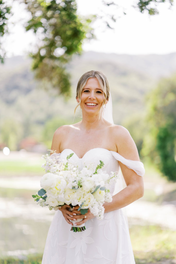 bride smiling holding a bouquet