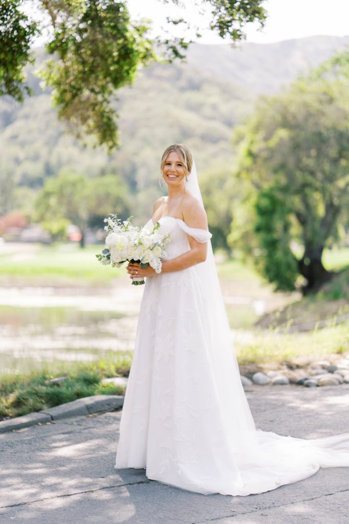 bride wearing white long dress with bouquet
