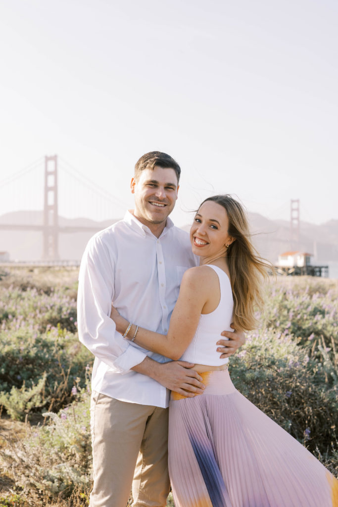 couple hugging in front of The Golden Gate Bridge