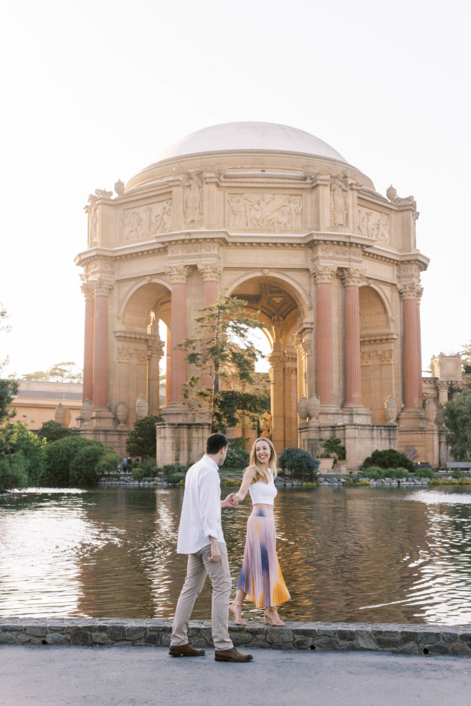 couple walking in front of the palace of fine arts