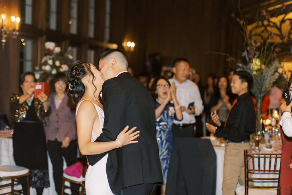 groom and bride sharing a kiss during reception