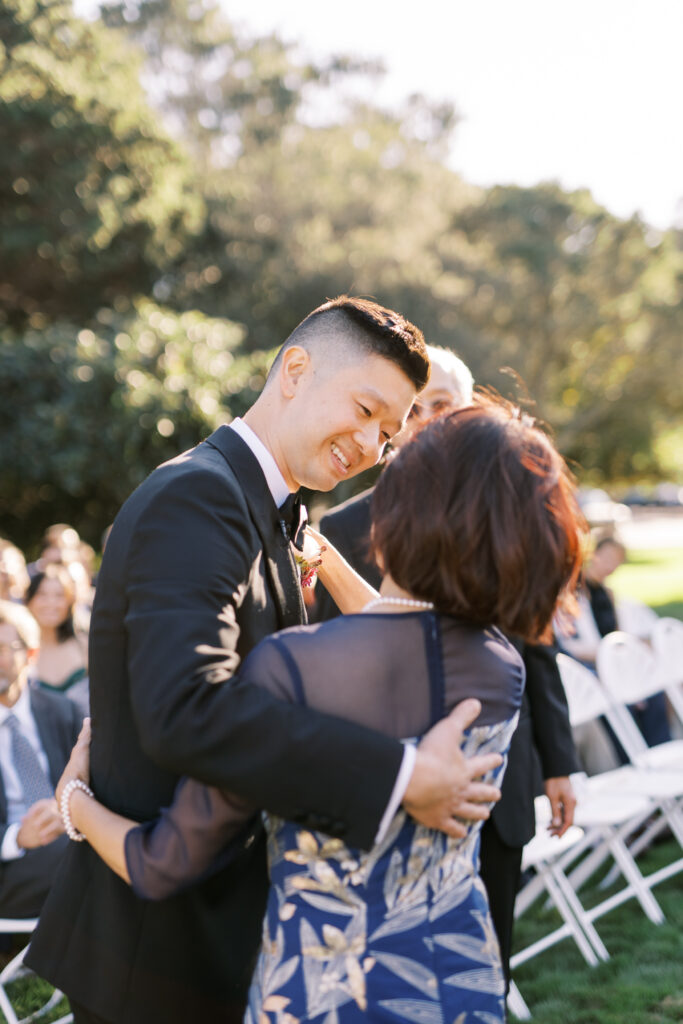 groom hugging the mother