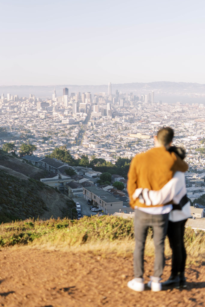 engaged couple enjoying the view of the city
