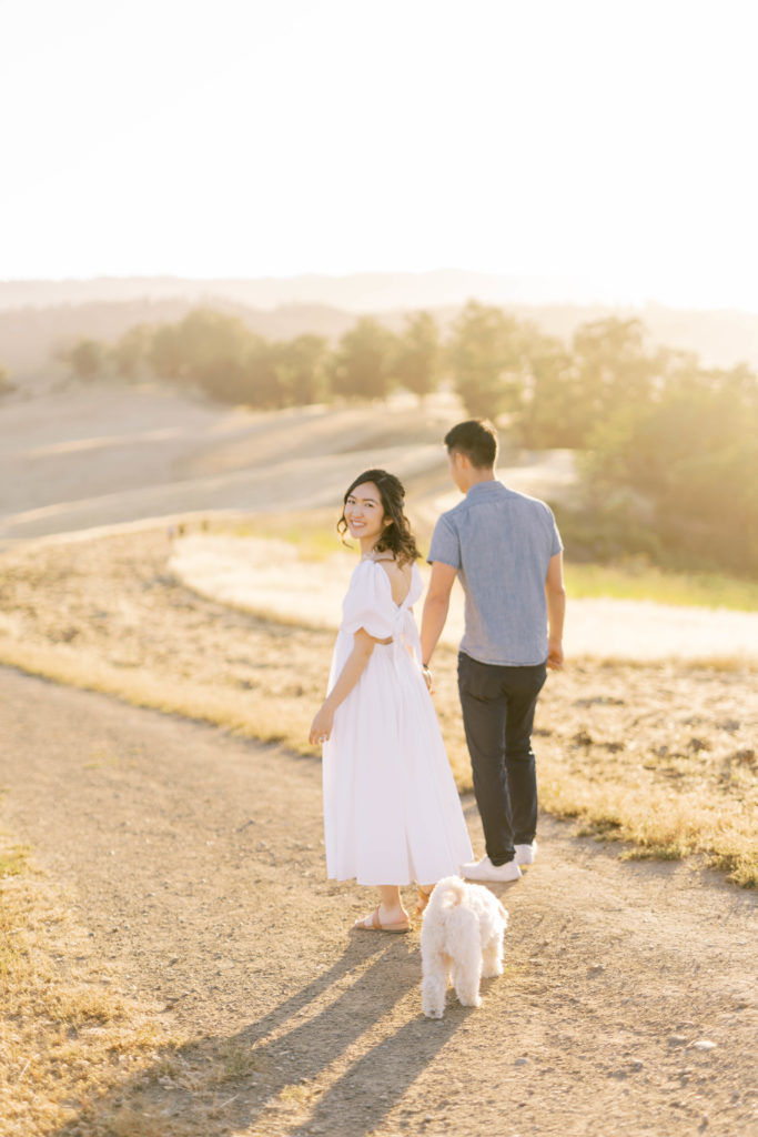 engaged couple and their dog following the Arastradero trails