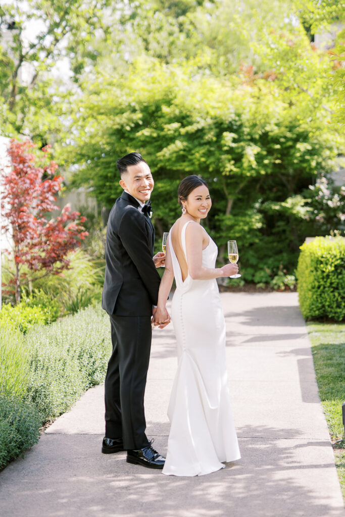 bride and groom turning back with their drinks