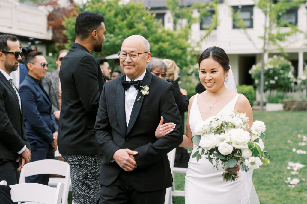 bride walking down the aisle with father