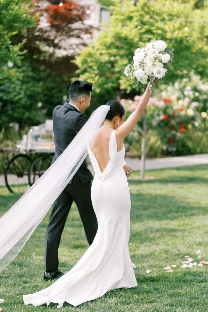 couple happily exiting the wedding ceremony venue