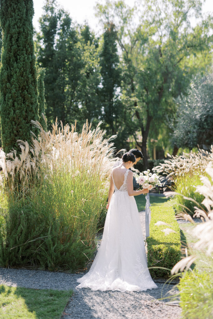 bride and groom portrait amidst the green grass of rosewood sandhill