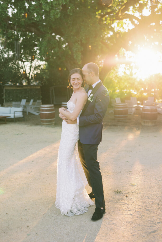 groom holding bride from behind 
