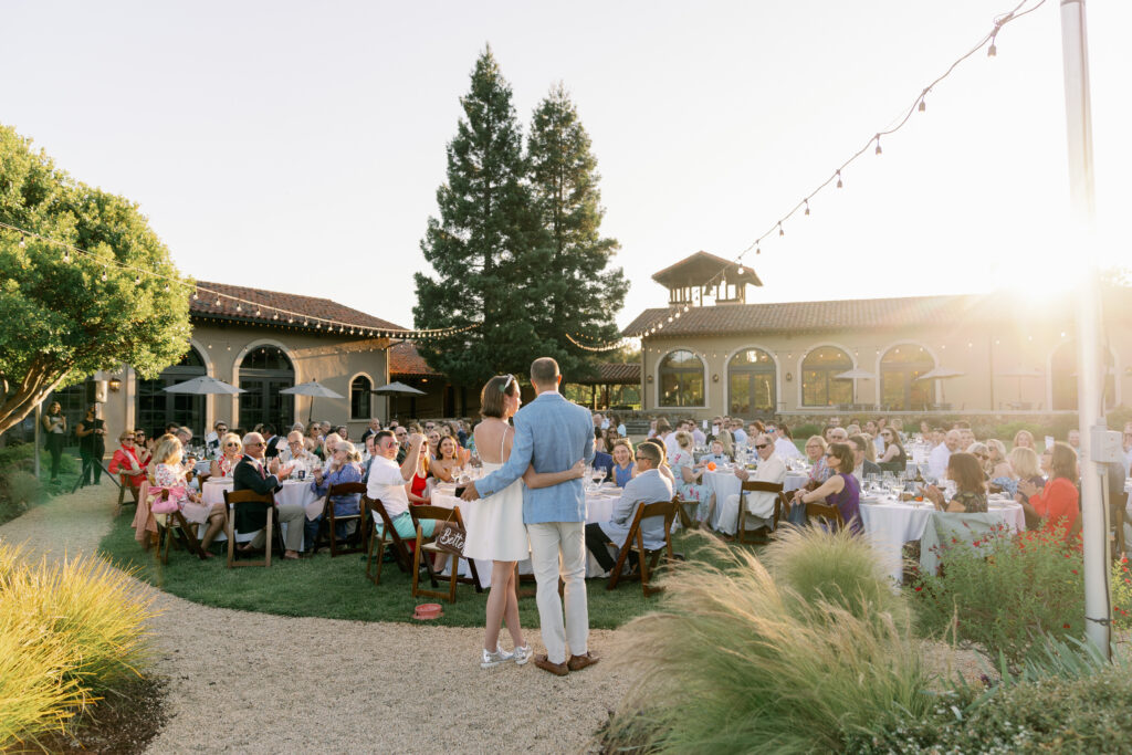 bride and groom with entire wedding party during their st francis winery reception at sunset