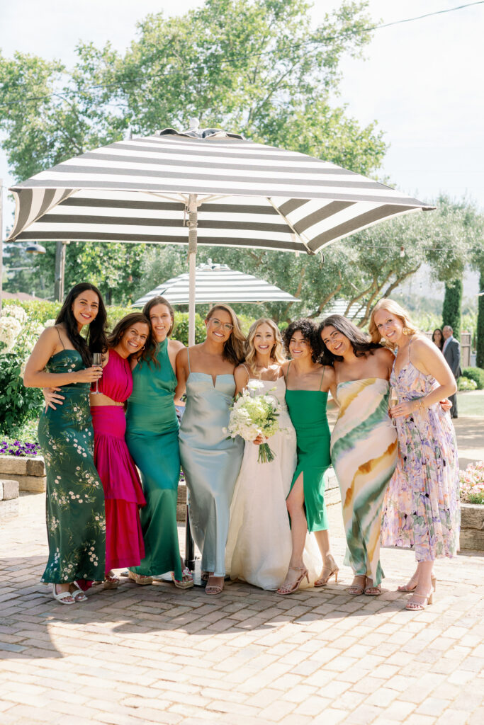 bride posing for a picture with bridesmaids