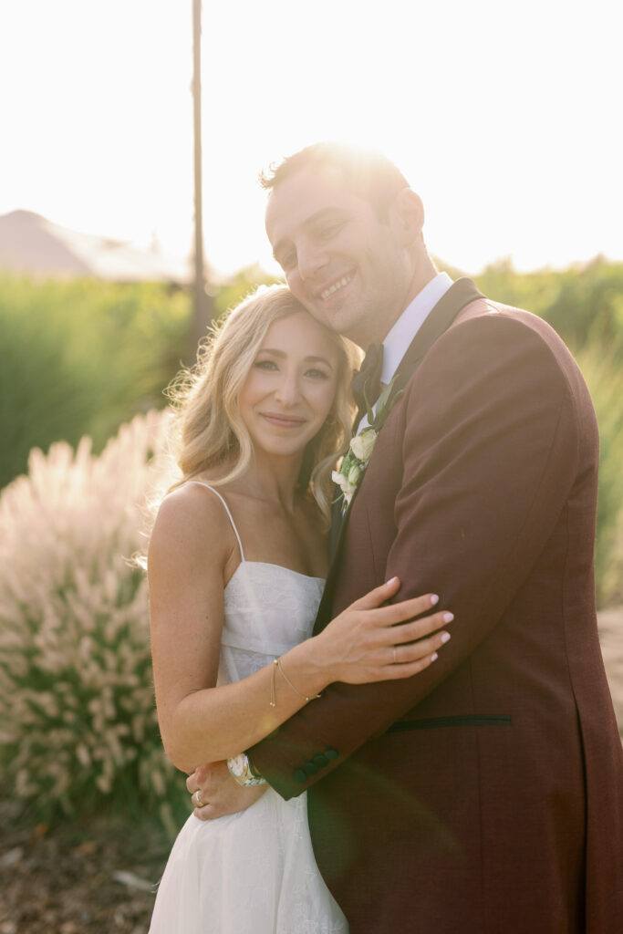 bride and groom hugging during sunset photoshoot