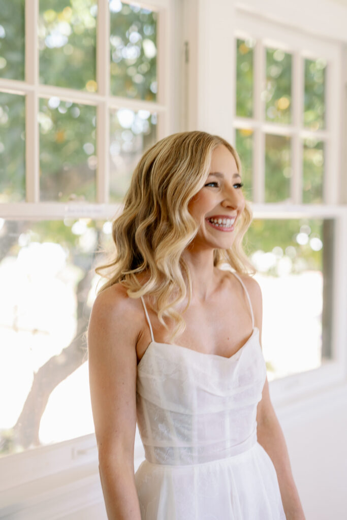 closeup photo of bride in white gown smiling