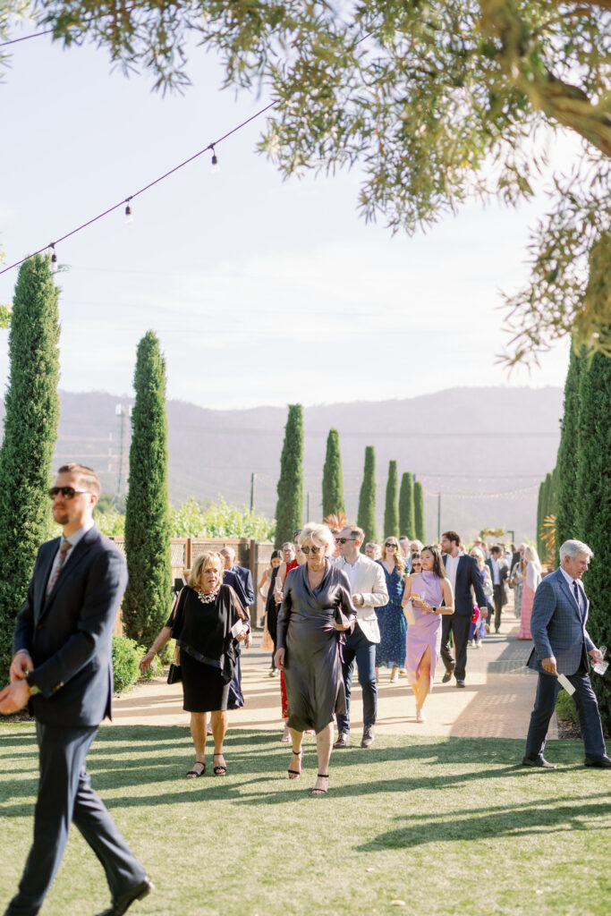 candid photo of guests walking from the ceremony venue