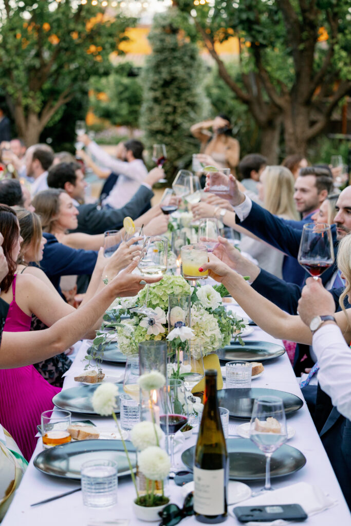 guests at the wedding receptions raising a glass for the couple